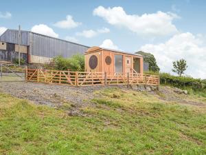 a small house sitting on top of a field at The Sawyers Hut-uk39775 in Trefeglwys