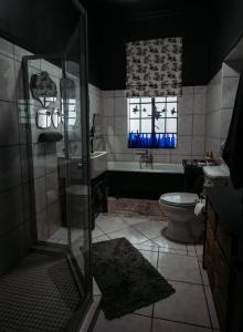 a bathroom with a shower and a sink and a toilet at Grewar House in Parys +39 photos