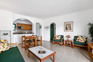 een woonkamer met een bank en een tafel bij Spacious Sunny Relaxing Lanzarote in Puerto del Carmen