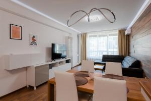 a living room with a table and a couch at New Stylish 1-bedroom Flat in Business District in Sofia