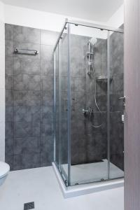 a shower with a glass door in a bathroom at New Stylish 1-bedroom Flat in Business District in Sofia