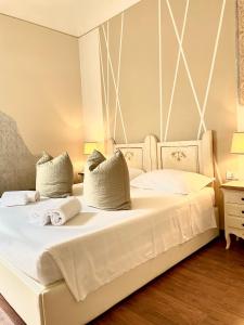 a bedroom with a large white bed with two pillows at Soggiorno Pezzati in Florence