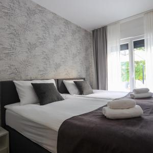 two beds sitting next to each other in a bedroom at Vila Monia in Zvornik +55 photos