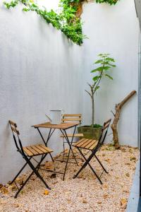 a table and two chairs and a table and a tree at Stylishly furnished private home in a vibrant area in Antwerp
