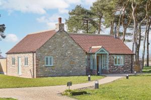 a small brick house with a red roof at The Irishman's Cottage in Yedingham