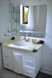 a bathroom with a white sink and a mirror at Royal Victoria House in Kampala
