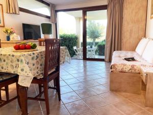a living room with a table with fruit on it at Sardegna Beach Eucalyptus in Golfo Aranci