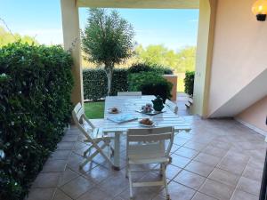 a table and chairs sitting on a patio at Sardegna Beach Eucalyptus in Golfo Aranci