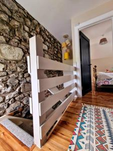 a room with a stone wall and a stair case at Beech Tree Cottage 