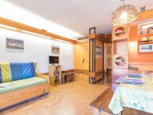 a living room with a couch and a table at Studio pour 4 pers à Chantemerle, Serre-Chevalier avec balcon, parking et équipements complets - FR-1-330E-70 in Saint-Chaffrey