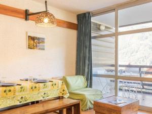 a living room with a couch and a large window at Studio pour 4 pers à Chantemerle, Serre-Chevalier avec balcon, parking et équipements complets - FR-1-330E-70 in Saint-Chaffrey
