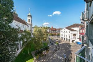 a view of a city street with a clock tower at Central Lucerne Apartments in Lucerne