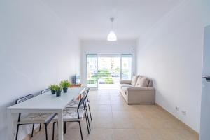 a living room with a table and a couch at Rochato Dreams in Portimão