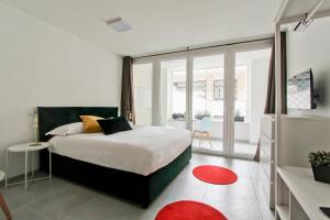 a bedroom with a bed and a large window at Vatican Loft in Rome