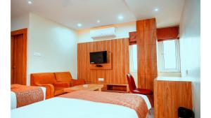 a hotel room with two beds and a tv at Hotel Teesta Stay, Rampurhat in Tarapith +49 photos