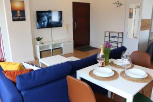 a living room with a blue couch and a table at Shik & Chic in the Heart of Burgas # 5min from beach # New in Burgas