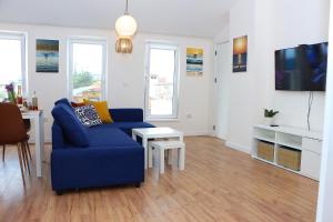 a living room with a blue couch and a table at Shik & Chic in the Heart of Burgas # 5min from beach in Burgas City