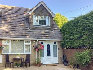 a house with a white door and a fence at Farriers in Bransgore