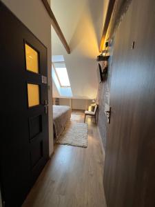 a door to a bedroom with a bed and a window at Comfort Zone Ostróda DUO in Grabin