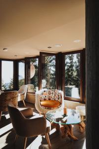 a living room with chairs and a table and windows at Hotel and SPA Moreni in Sofia