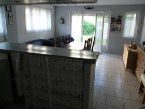 a bar in a living room with a table and chairs at 75 sqm Noyon; independant house in Noyon +1 photo