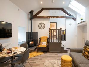 a living room with a table and a fireplace at Bryn Eglwys in Llanegryn