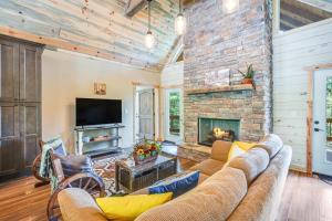 a living room with a couch and a fireplace at Lofty Escape in Ellijay