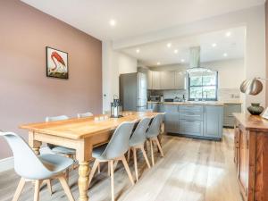 a kitchen and dining room with a wooden table and chairs at Gwrlodde in Talgarth