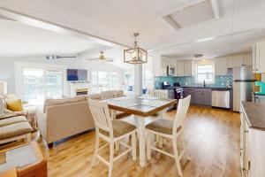 a kitchen and living room with a table and chairs at Montego Bay - Sea Lane in Ocean City