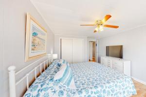 a bedroom with a bed and a ceiling fan at Montego Bay - Sea Lane in Ocean City +21 photos