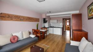 a living room with a couch and a dining room at APARTAMENTY TR 11 Apartament nr 4 in Olsztyn
