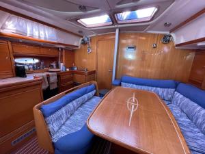 AIDA Sailing Boat في سلانيك: غرفة طعام مع طاولة خشبية وكراسي زرقاء