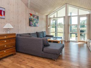a living room with a couch and a table at 12 person holiday home in R m in Rømø Kirkeby
