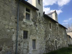 an old stone building with a tower on top of it at Manoir de Valette in Chartrené