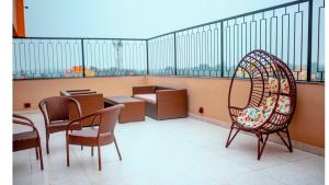 a balcony with chairs and tables in a building at Hotel Dc Star in Tarapith