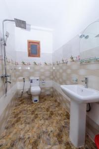a bathroom with a toilet and a sink at Scenery River Star Hotel in Hikkaduwa +53 photos