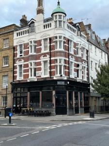 a large brick building on the corner of a street at Bell House Hostel in London