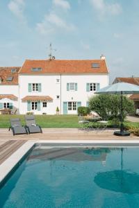 a house with a swimming pool in front of a house at Domaine de Jouarre in Jouarre