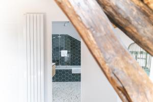 a bathroom with a shower with a black and white tile at Domaine de Jouarre in Jouarre