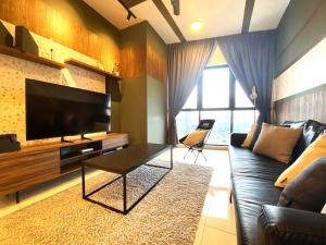 a living room with a couch and a flat screen tv at Infini Suites@ Continew Residence KL in Kuala Lumpur