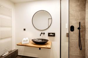 a bathroom with a sink and a mirror at Hotel Westerkamp in Osnabrück