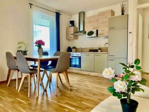 a kitchen and dining room with a table and chairs at Apartment Seenah Zentral in Pörtschach am Wörthersee