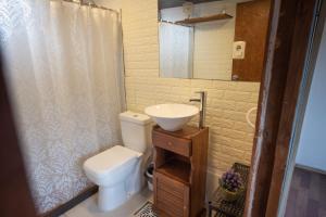 a small bathroom with a toilet and a sink at RocaMar Hostel Boutique in Punta del Este +94 photos