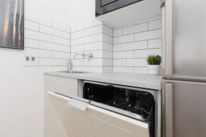 a kitchen with a sink and a dishwasher at Warsaw Stawki Cosy Apartment by Renters in Warsaw