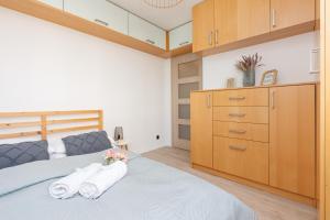 1 dormitorio con 1 cama con toallas en Warsaw Stawki Cosy Apartment by Renters, en Varsovia