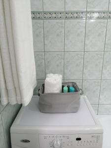 a washing machine with a basket on top of it at Pandora Guest House in Cluj-Napoca