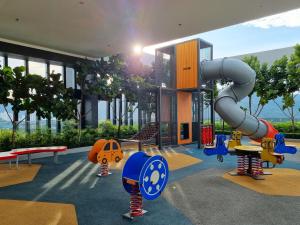 a childrens play area in a building with a playground at Lavish Beacon Executive Suites by Bin Dao Wu Homestay Penang in George Town