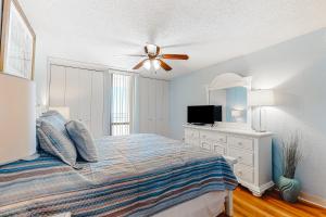a bedroom with a bed and a ceiling fan at Pyramid V in Ocean City