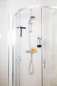 a shower with a glass enclosure in a bathroom at Bob W Commercial House in London