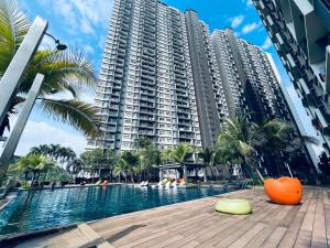 a large apartment building with a pool and palm trees at Kama Homestay @Wangsa Maju in Kuala Lumpur